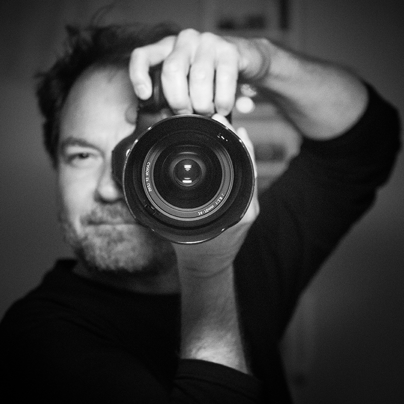 Profile image of a photographer with a camera