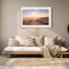 Minimalist living room featuring a low wooden sofa, beige and cream cushions, woven baskets, and the 'Helderberg Marine Protected Area' Print as wall art. Soft natural light enhances the cosy, serene ambience.