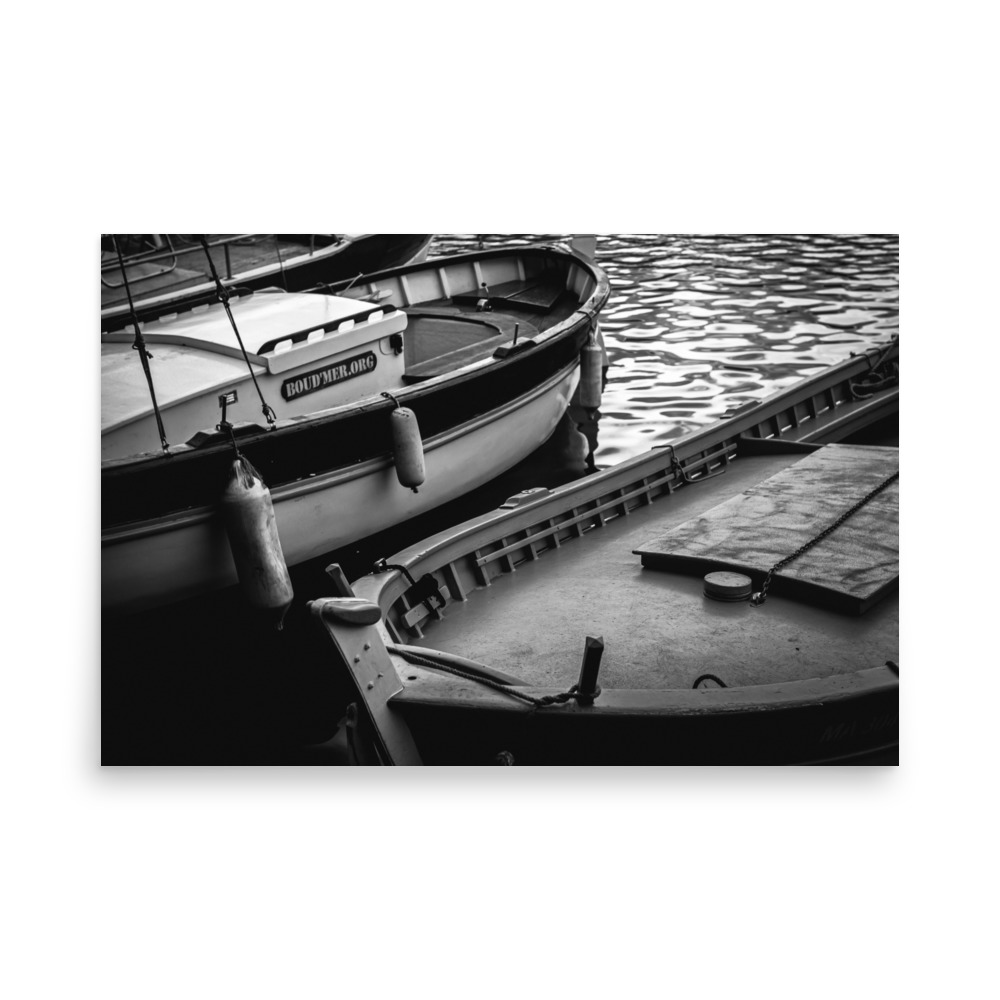 The 'Harbour Boats' Print features a black and white photo of two moored boats floating on calm water, showcasing reflections plus details like ropes, fenders, and wooden planks.