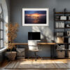 A modern home office with a desk, white chair, computer, and shelves sits by a large arched window. Above the desk, the ‘Fire in the Sky’ Print warms the grey wall. A dried plant adds a natural touch in the corner.