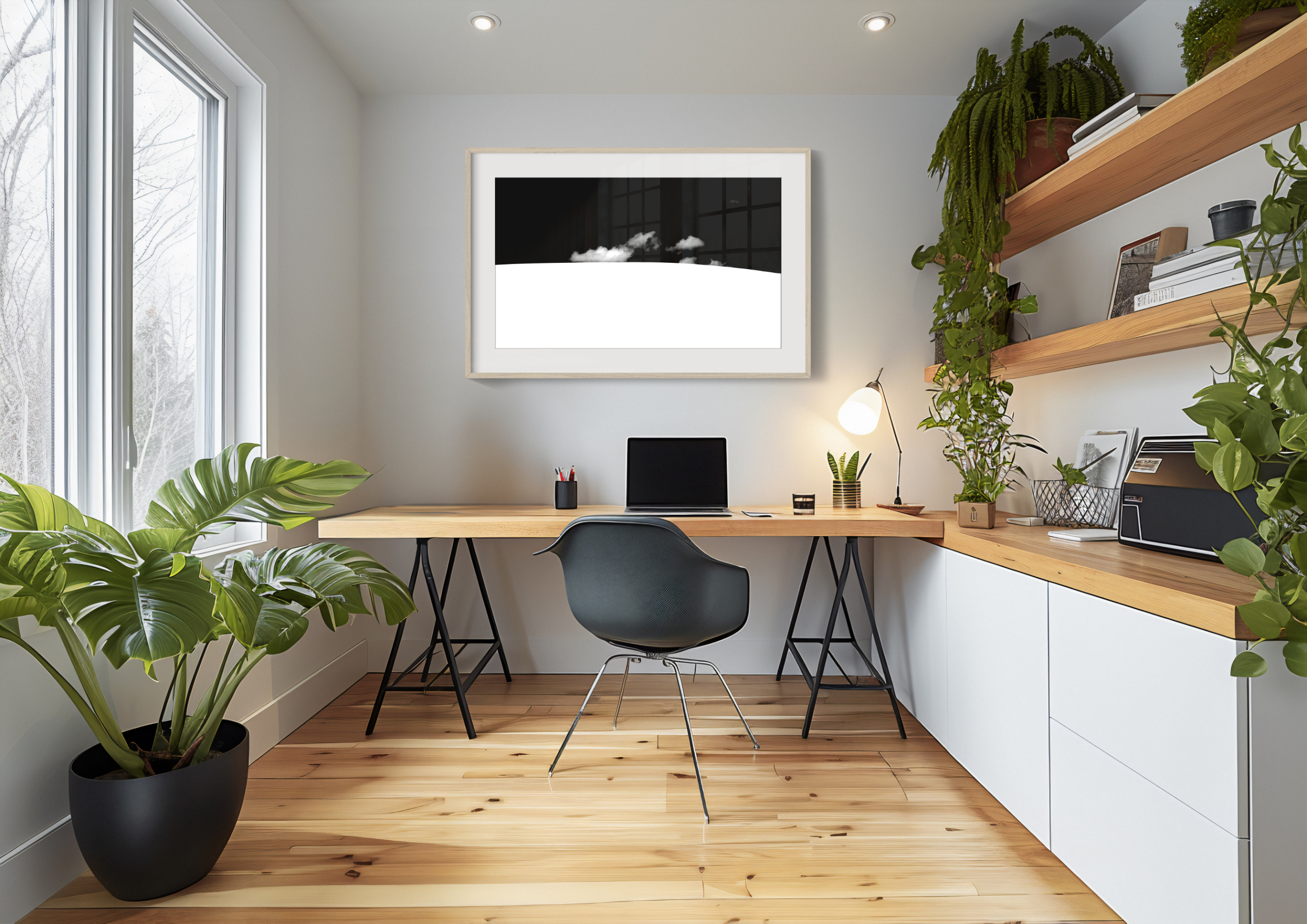 A modern home office with a wooden desk, black chair, potted plants, and floating shelves sits beneath a large framed 'Waenhuiskrans Dunes Minimalistic' print. Natural light pours in through the large windows on the left.