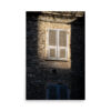 Sunset Shutters" Print: Sunlit shutters brighten a weathered stone wall whilst a shaded window rests below, highlighting the rich texture of aged stones.