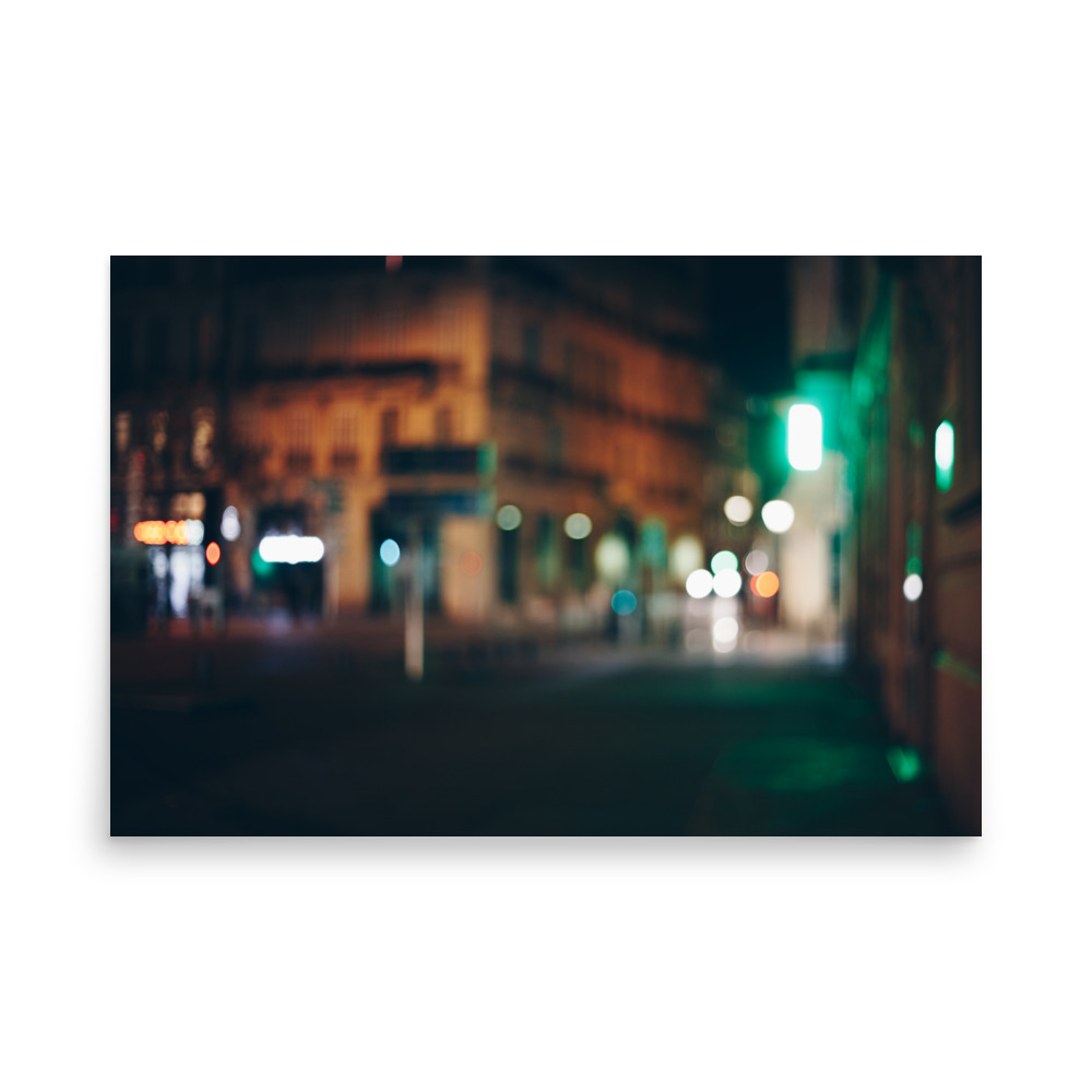 The 'Paris Night II' Print captures a dreamy scene of a city street at night, with soft, blurred lights from buildings and streetlamps creating an atmospheric, indistinct ambience.